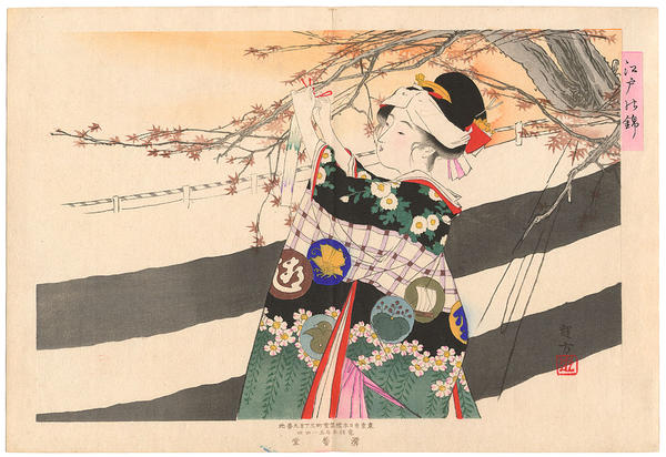 Woman attaching a poem strip to a maple tree