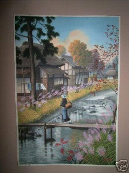 Woman walking across footbridge over stream