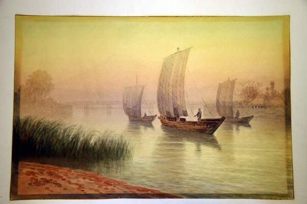 Sailboats on river with background bridge